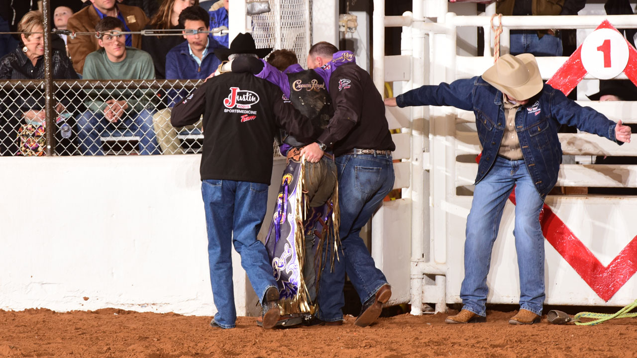 Men help injured man out of the arena